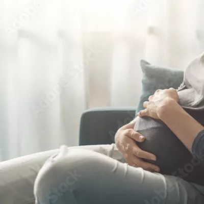 pregnant woman sitting on a sofa