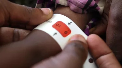 A child's upper arm being measured
